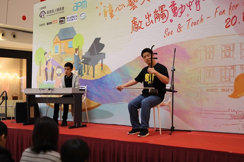 Visually impaired members, Lau Yik Keung (left) and Ethan Yang (right) playing piano and Erhu